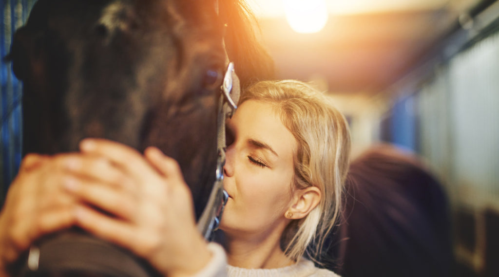 woman hugging horse