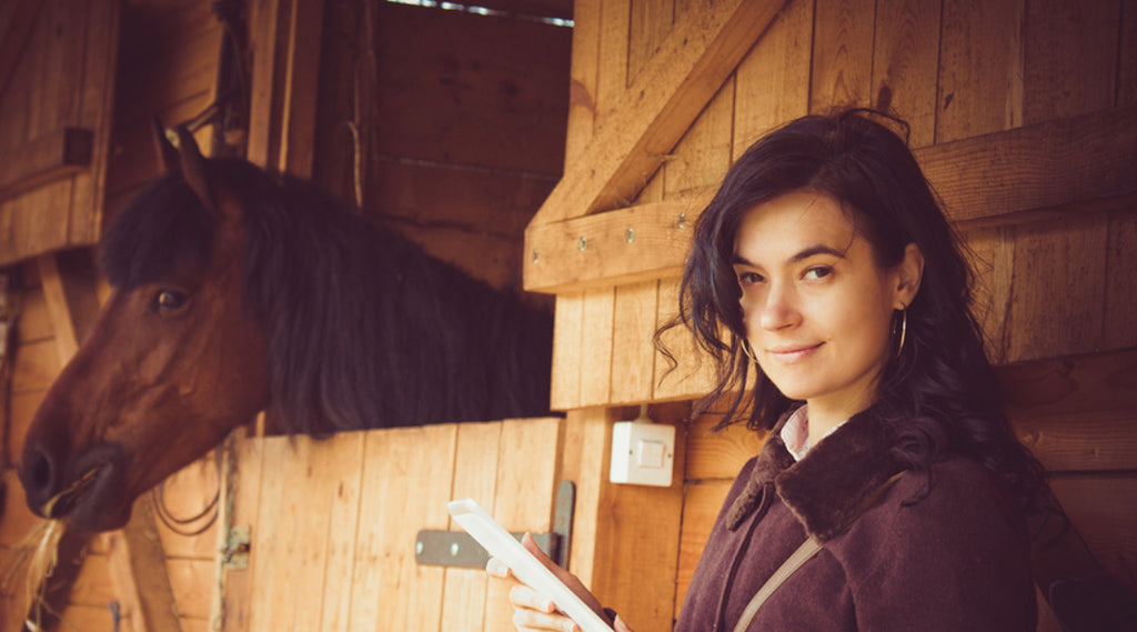 woman with stabled horse